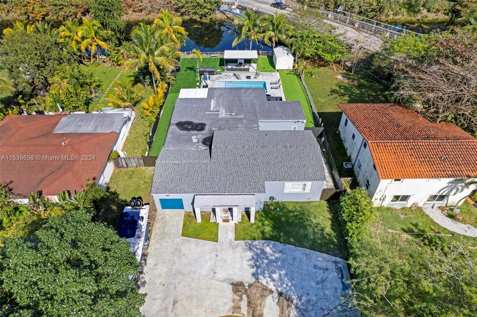 an aerial view of a house with a yard pool patio and outdoor seating