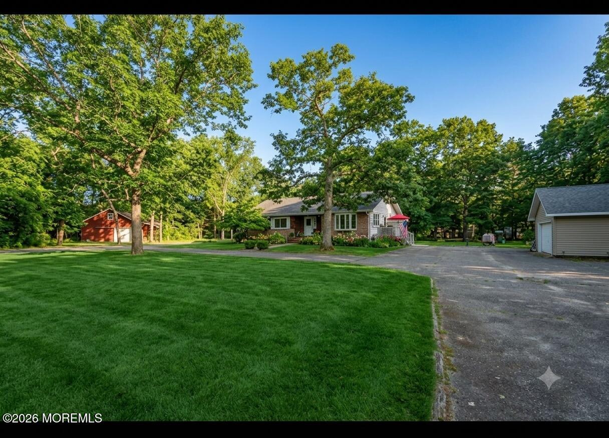 745 Oak Glen Road Howell, NJ 07731 - Photo 1 of 46 a front view of a house with a yard