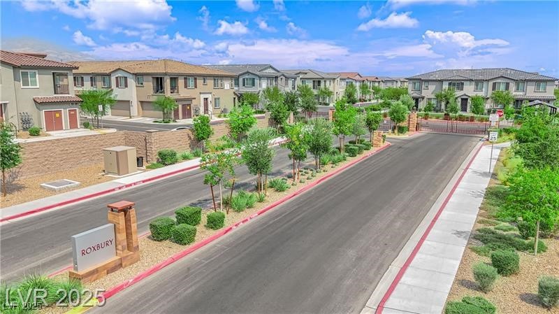 7308 North Decatur Boulevard, Unit 4 North Las Vegas, NV 89084 - Photo 30 of 34 View of asphalt street with curbs, sidewalks, a residential view, and a gated entry