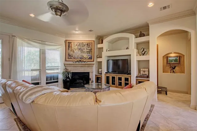 a living room with fireplace furniture and a flat screen tv