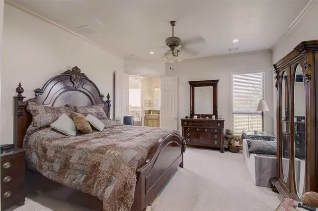 a bedroom with a bed couch and a window