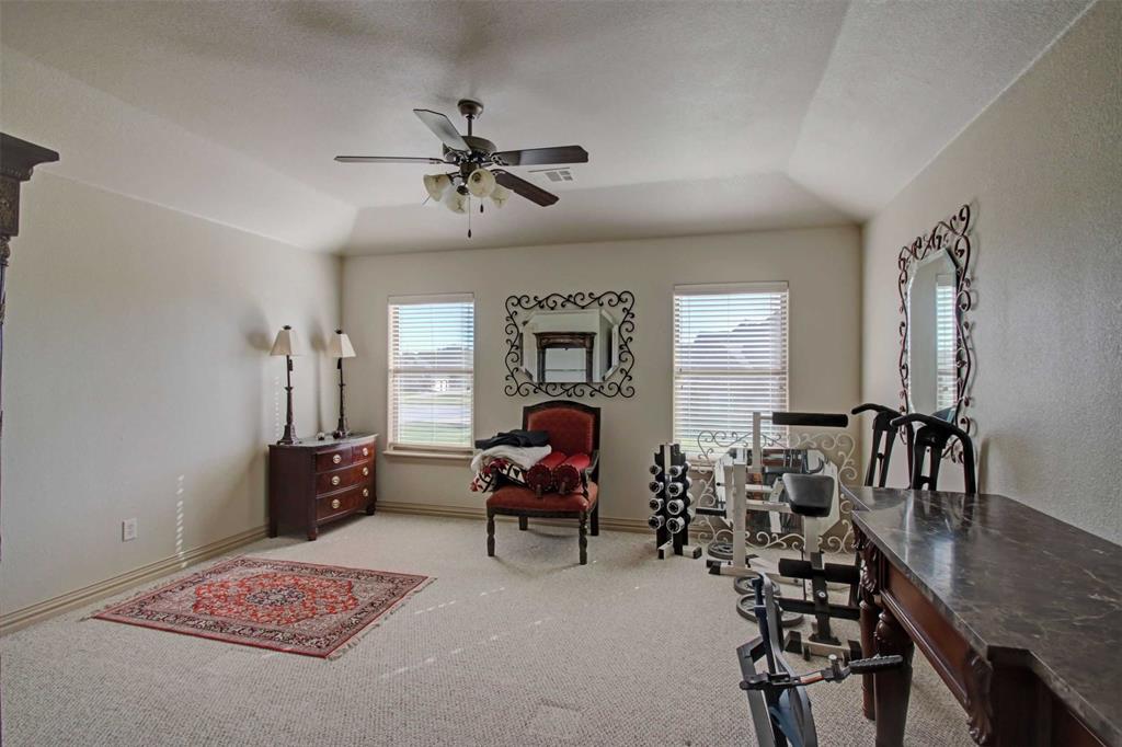 3705 Canyon Pass Trail Burleson, TX 76028 - Photo 23 of 32 a bedroom with furniture and a chandelier