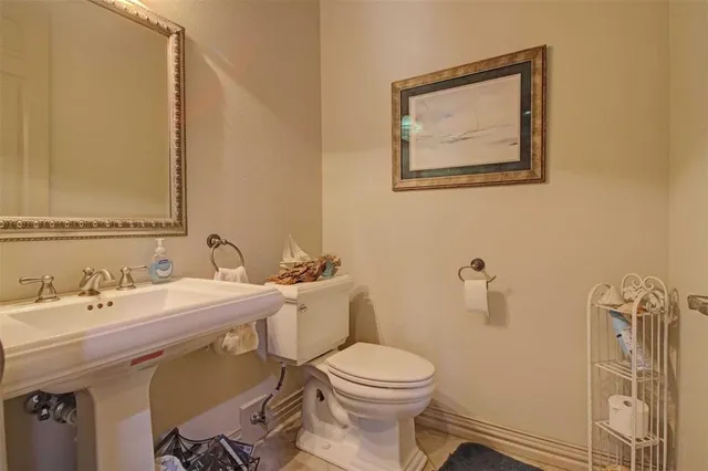 a bathroom with a toilet a sink and mirror