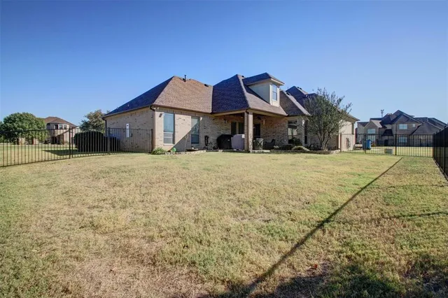a view of a house with a yard and a fountain