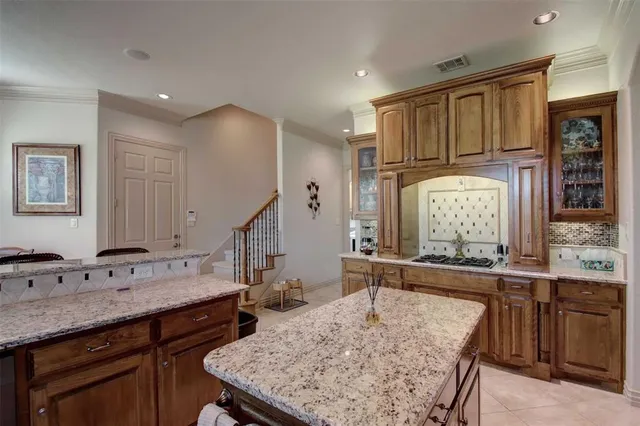 a kitchen with sink refrigerator and cabinets