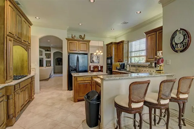 a large kitchen with a table and chairs