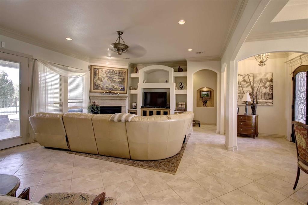 3705 Canyon Pass Trail Burleson, TX 76028 - Photo 10 of 32 a living room with furniture a fireplace and a flat screen tv
