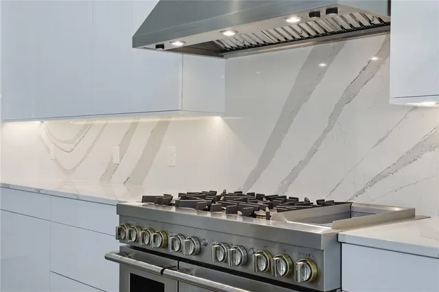 a large white room with a lot of white cabinets and a sink