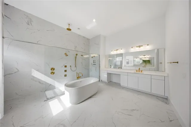 a view of staircase with lots of frames on wall and wooden floor