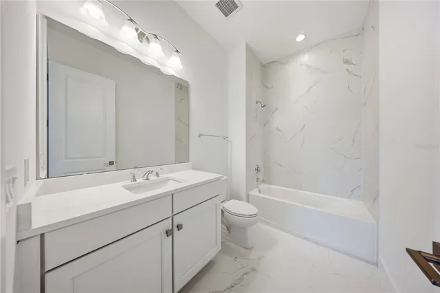a view of bathroom with a sink mirror and toilet