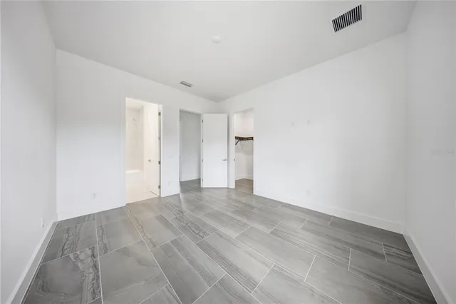 a view of a livingroom with workspace and large windows