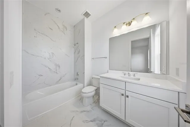 an aerial view of multiple houses with a big yard