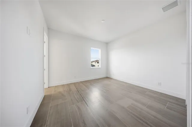 an aerial view of a house with a swimming pool and outdoor seating