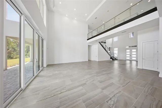 a view of kitchen with white cabinets and sink