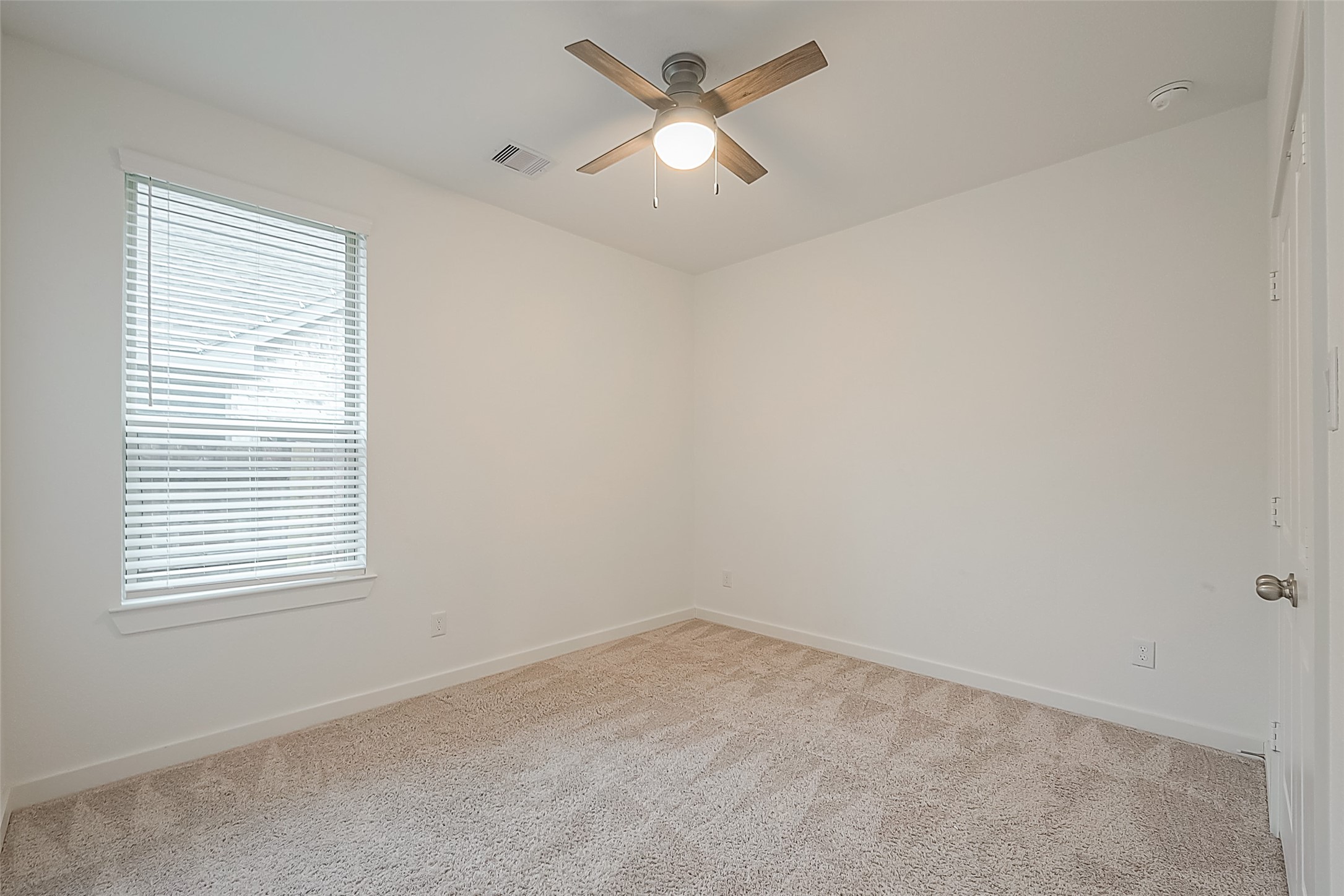 516 Timber Voyage Court Conroe, TX 77304 - Photo 11 of 25 an empty room with a window and a fan