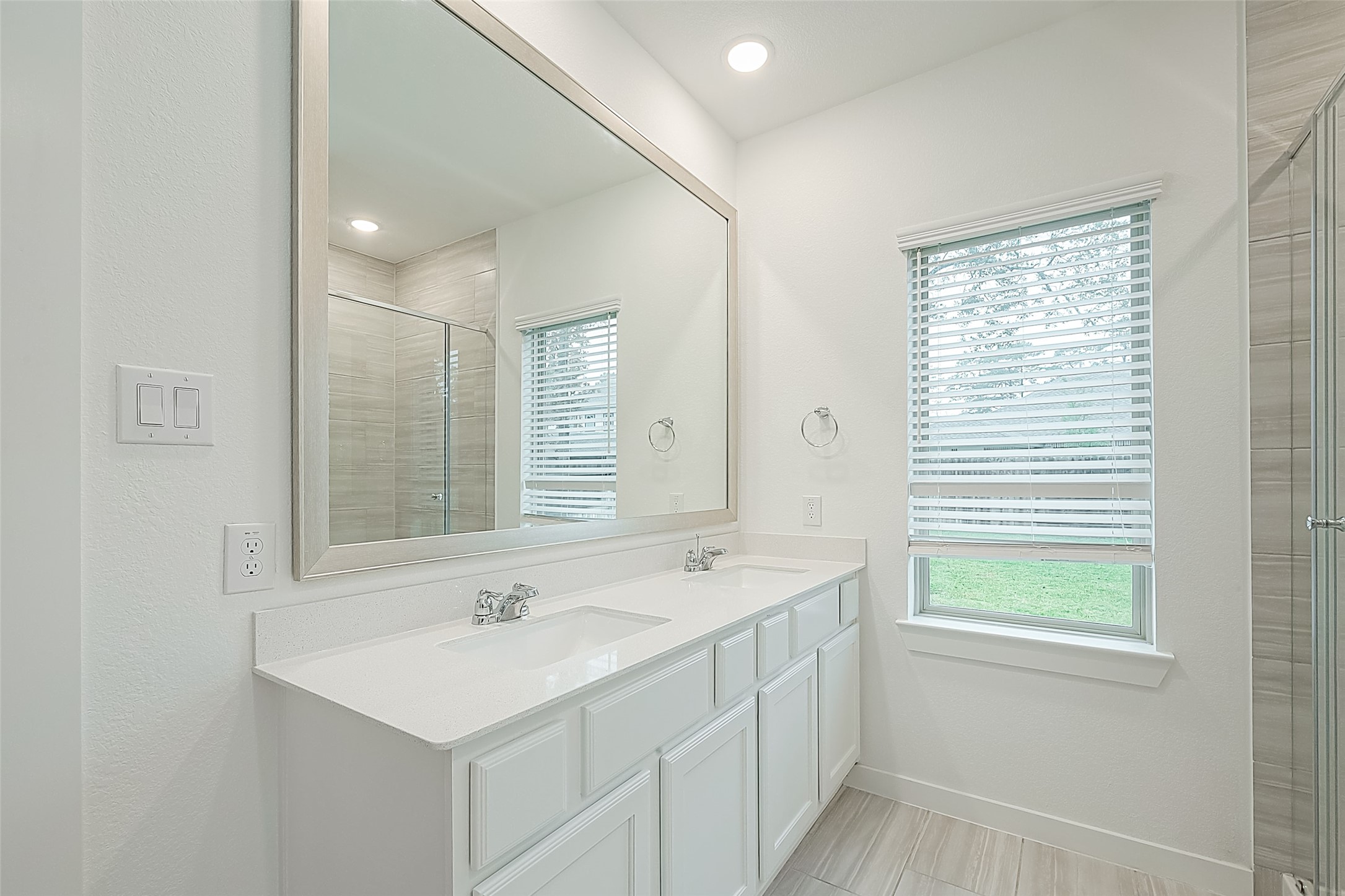 516 Timber Voyage Court Conroe, TX 77304 - Photo 17 of 25 a bathroom with a sink a mirror and a window