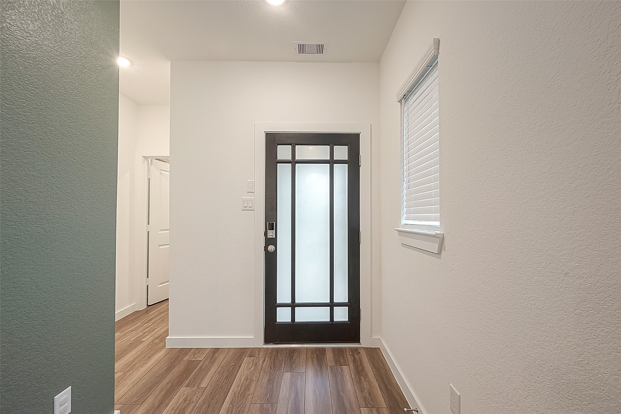 516 Timber Voyage Court Conroe, TX 77304 - Photo 4 of 25 an empty room with wooden floor and windows