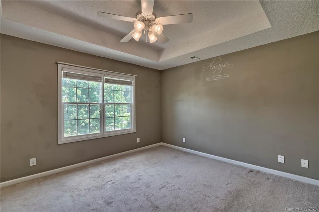 224 Maple Ridge Circle Salisbury, NC 28147 - Photo 22 of 43 en empty room with windows and ceiling fan