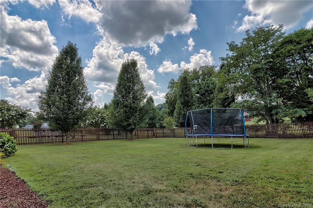 224 Maple Ridge Circle Salisbury, NC 28147 - Photo 42 of 43 a view of a backyard with wooden fence