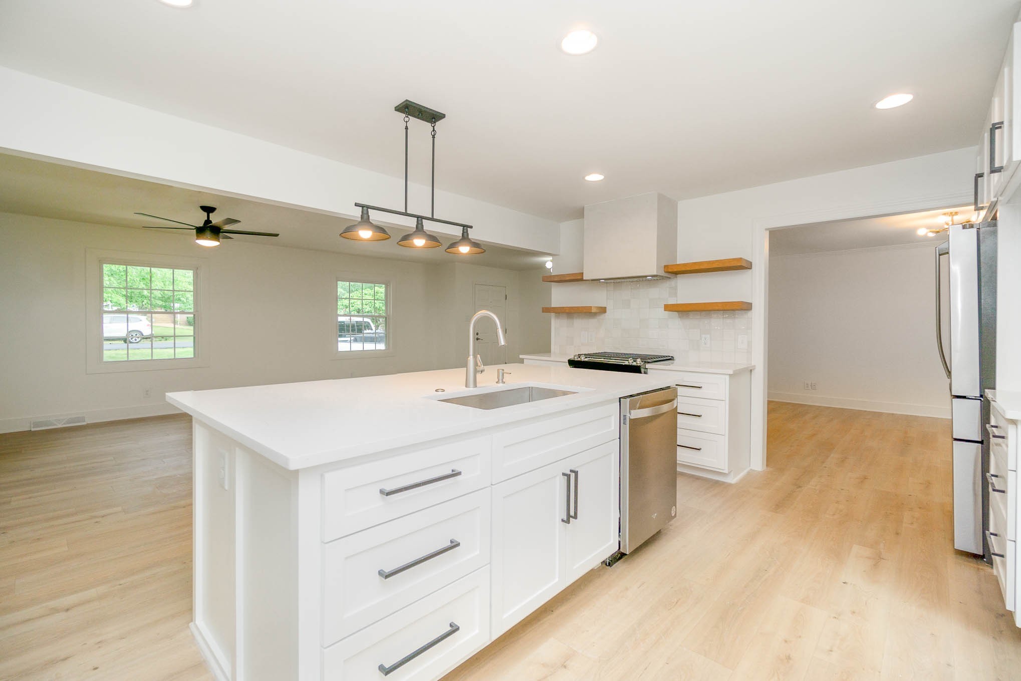 1401 Manor Road Columbia, TN 38401 - Photo 3 of 35 a kitchen with a sink a stove a refrigerator and white cabinets