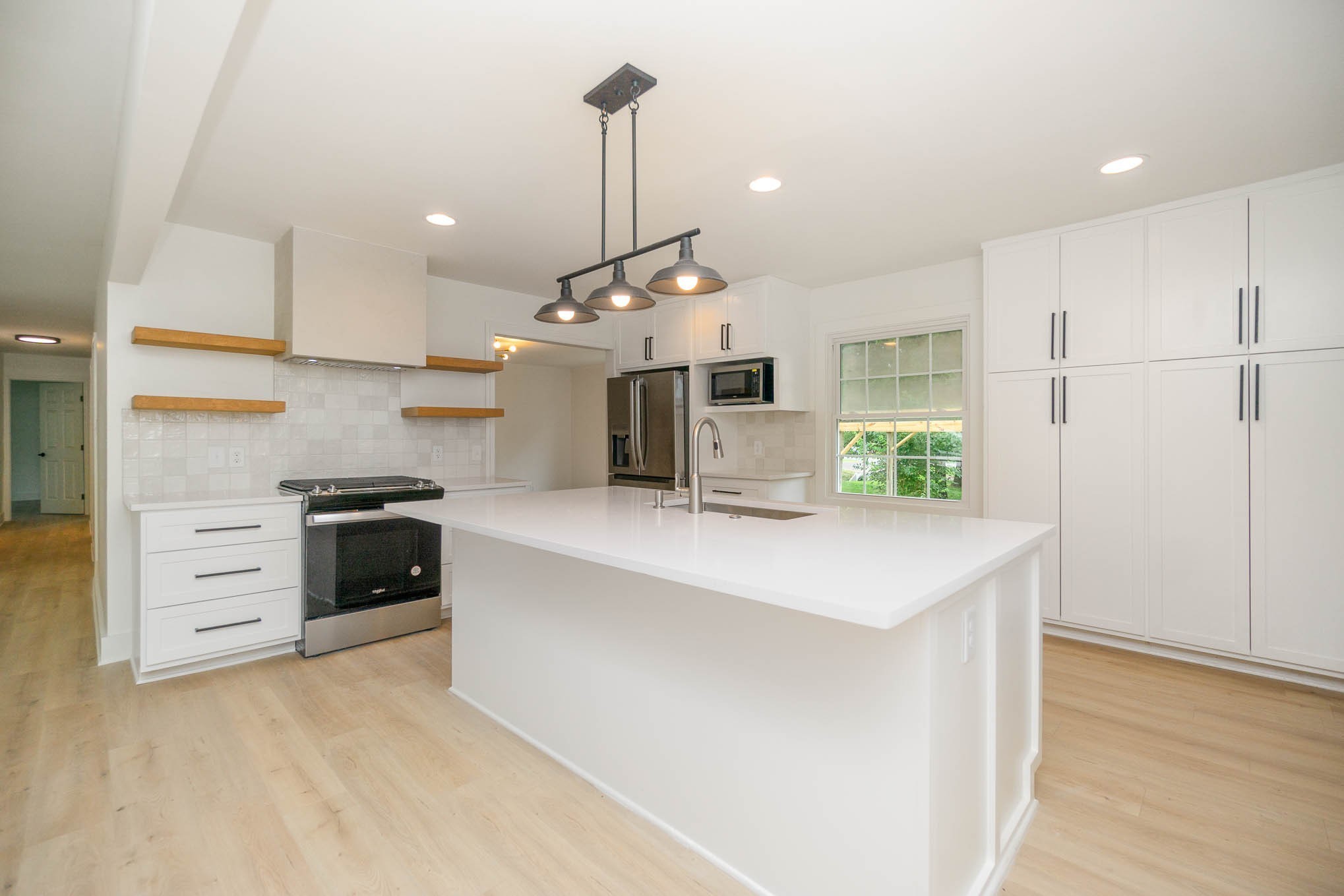 1401 Manor Road Columbia, TN 38401 - Photo 6 of 35 a large kitchen with stainless steel appliances a large counter top a stove a chimney a sink and a refrigerator