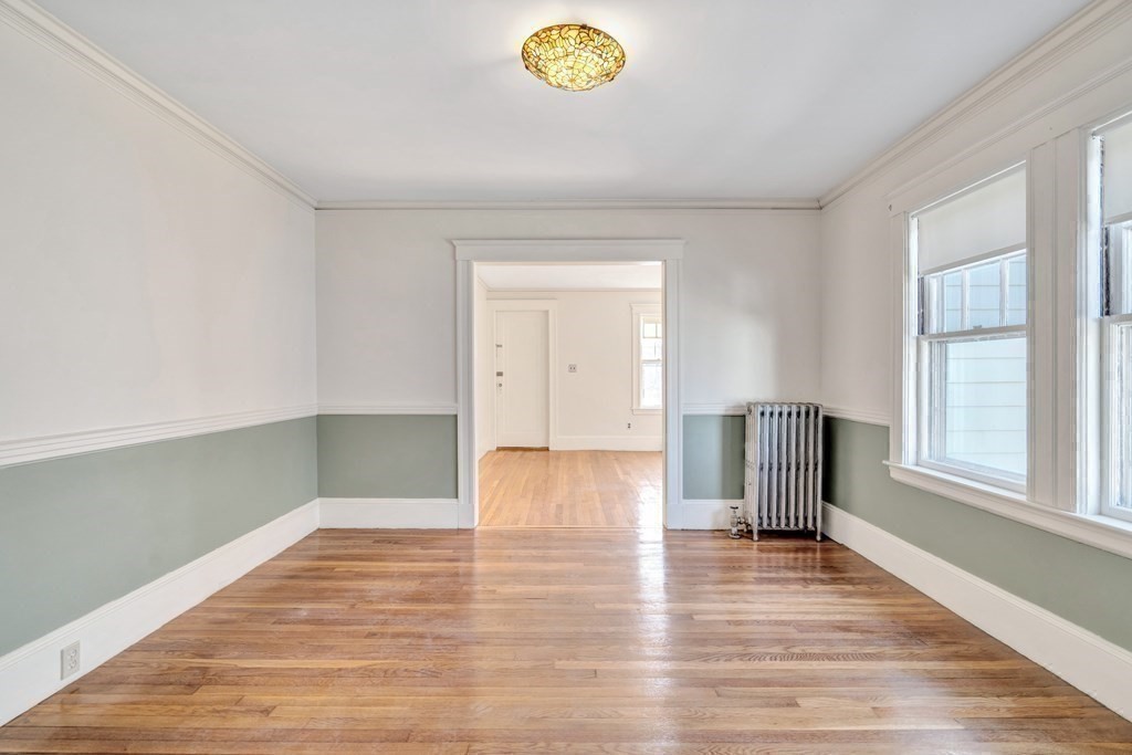 18-20 Walcott Road Watertown, MA 02472 - Photo 11 of 40 a view of empty room with wooden floor and fan