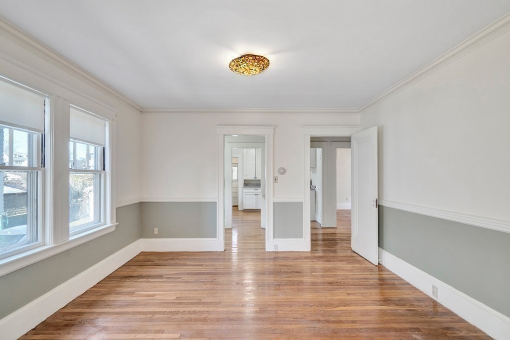 18-20 Walcott Road Watertown, MA 02472 - Photo 12 of 40 a view of empty room with wooden floor and window