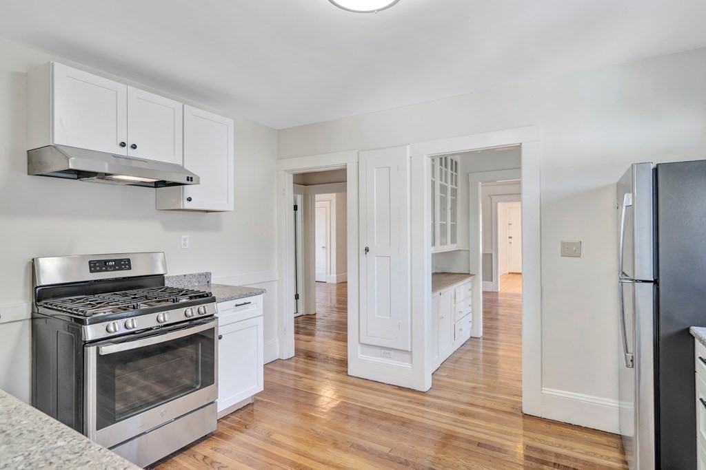 18-20 Walcott Road Watertown, MA 02472 - Photo 16 of 40 a kitchen with white cabinets and stainless steel appliances
