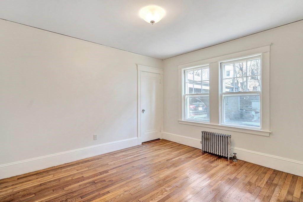 18-20 Walcott Road Watertown, MA 02472 - Photo 18 of 40 an empty room with wooden floor and windows