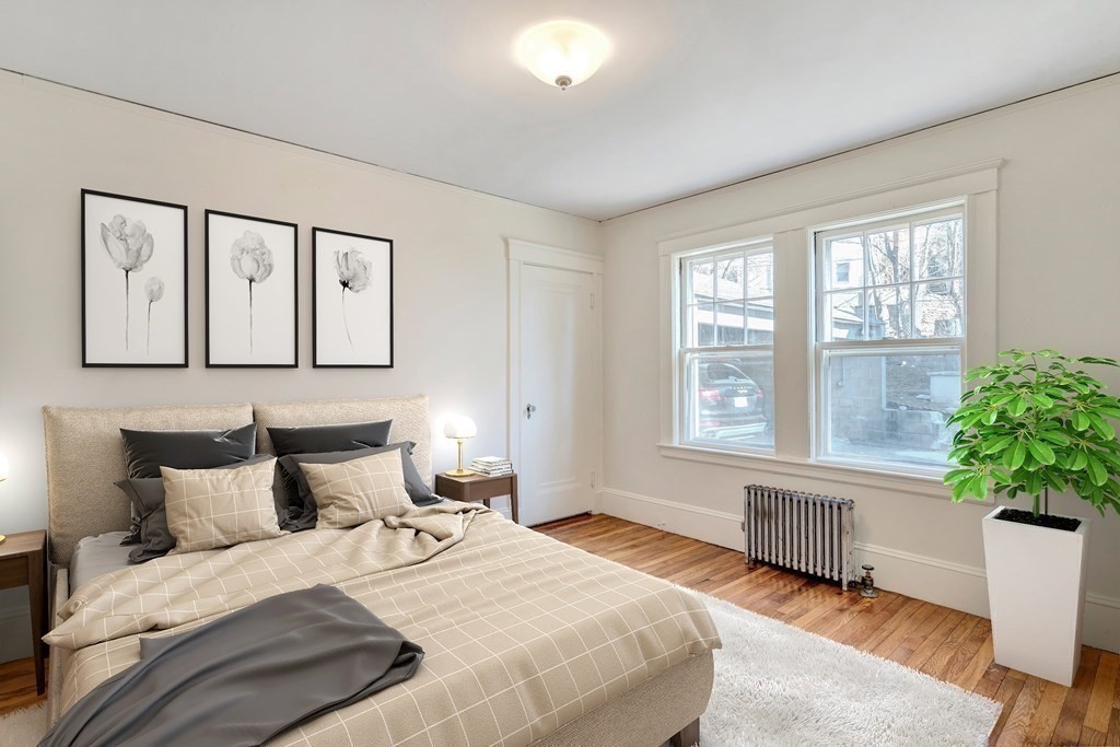 18-20 Walcott Road Watertown, MA 02472 - Photo 19 of 40 a bedroom with a bed and a large window