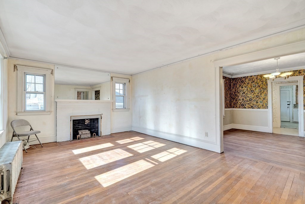 18-20 Walcott Road Watertown, MA 02472 - Photo 25 of 40 an empty room with fireplace wooden floor and windows