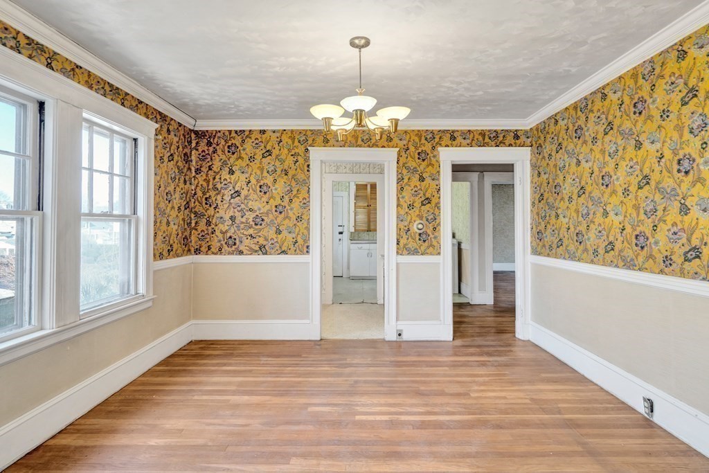 18-20 Walcott Road Watertown, MA 02472 - Photo 26 of 40 a view of an empty room with wooden floor and a window