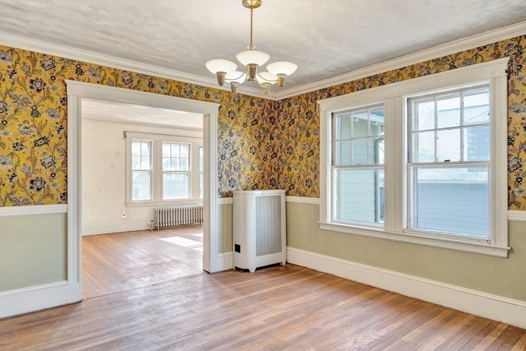 18-20 Walcott Road Watertown, MA 02472 - Photo 27 of 40 an empty room with wooden floor fan and windows