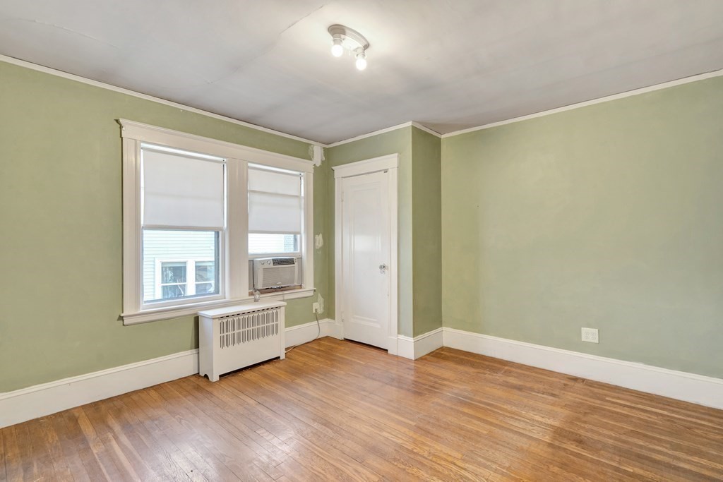 18-20 Walcott Road Watertown, MA 02472 - Photo 32 of 40 an empty room with wooden floor and windows