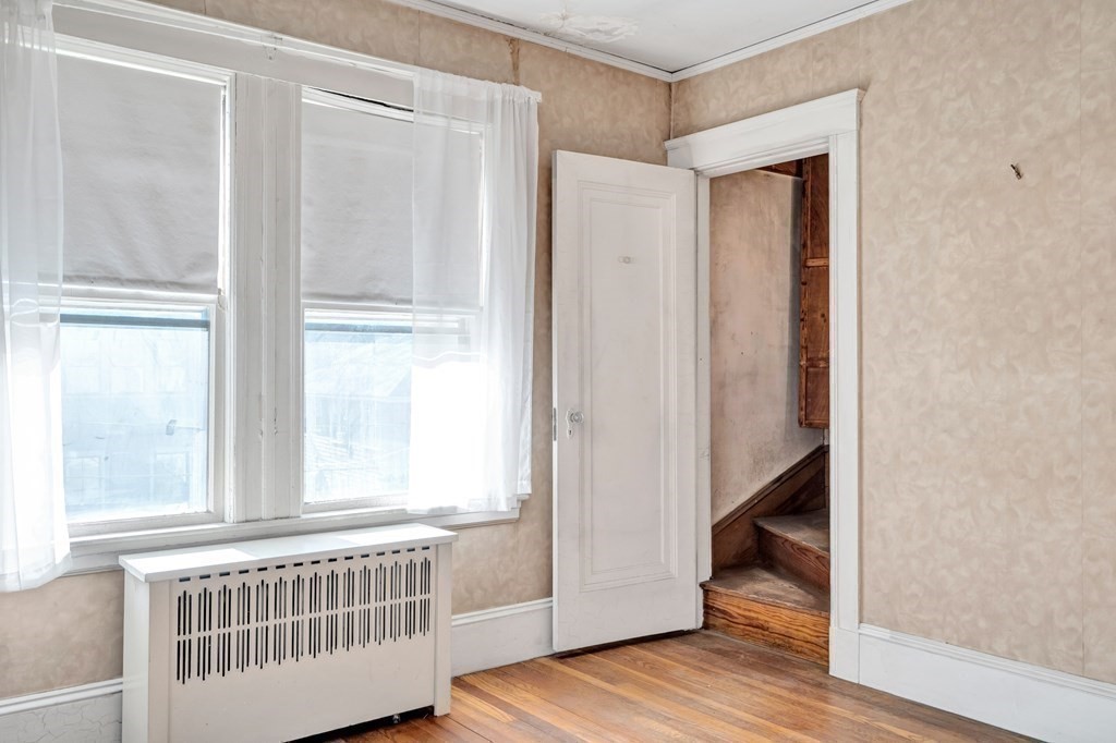 18-20 Walcott Road Watertown, MA 02472 - Photo 34 of 40 a view of a room with wooden floor and windows