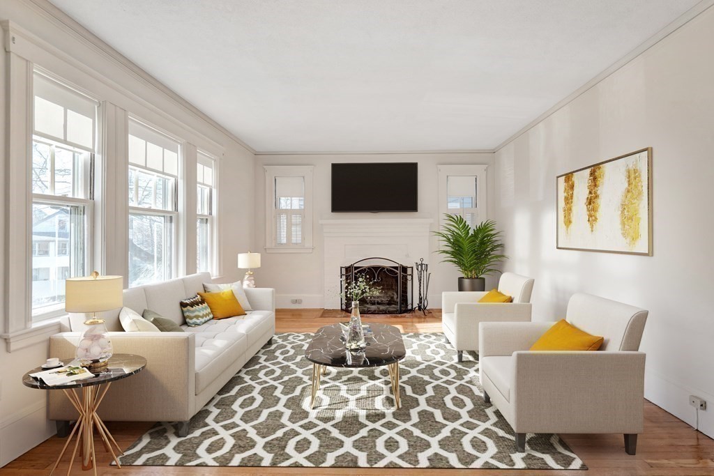 18-20 Walcott Road Watertown, MA 02472 - Photo 7 of 40 a living room with furniture a fireplace and a flat screen tv