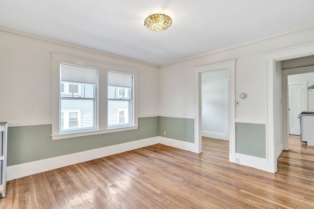 18-20 Walcott Road Watertown, MA 02472 - Photo 9 of 40 wooden floor in an empty room with a window