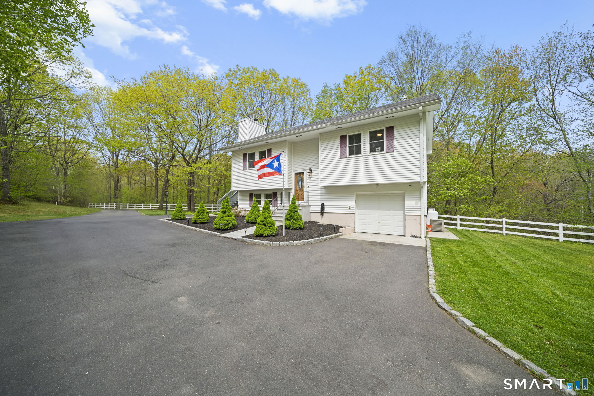 1118 Spindle Hill Road Wolcott, CT 06716 - Photo 4 of 38 a view of a house with a patio and a yard