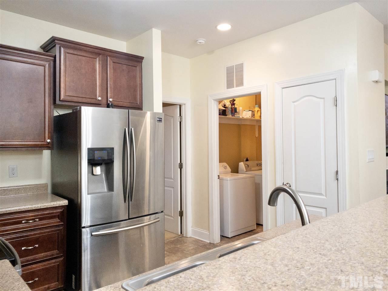 2513 Friendly Trail Raleigh, NC 27610 - Photo 12 of 29 a kitchen with granite countertop a refrigerator and a sink