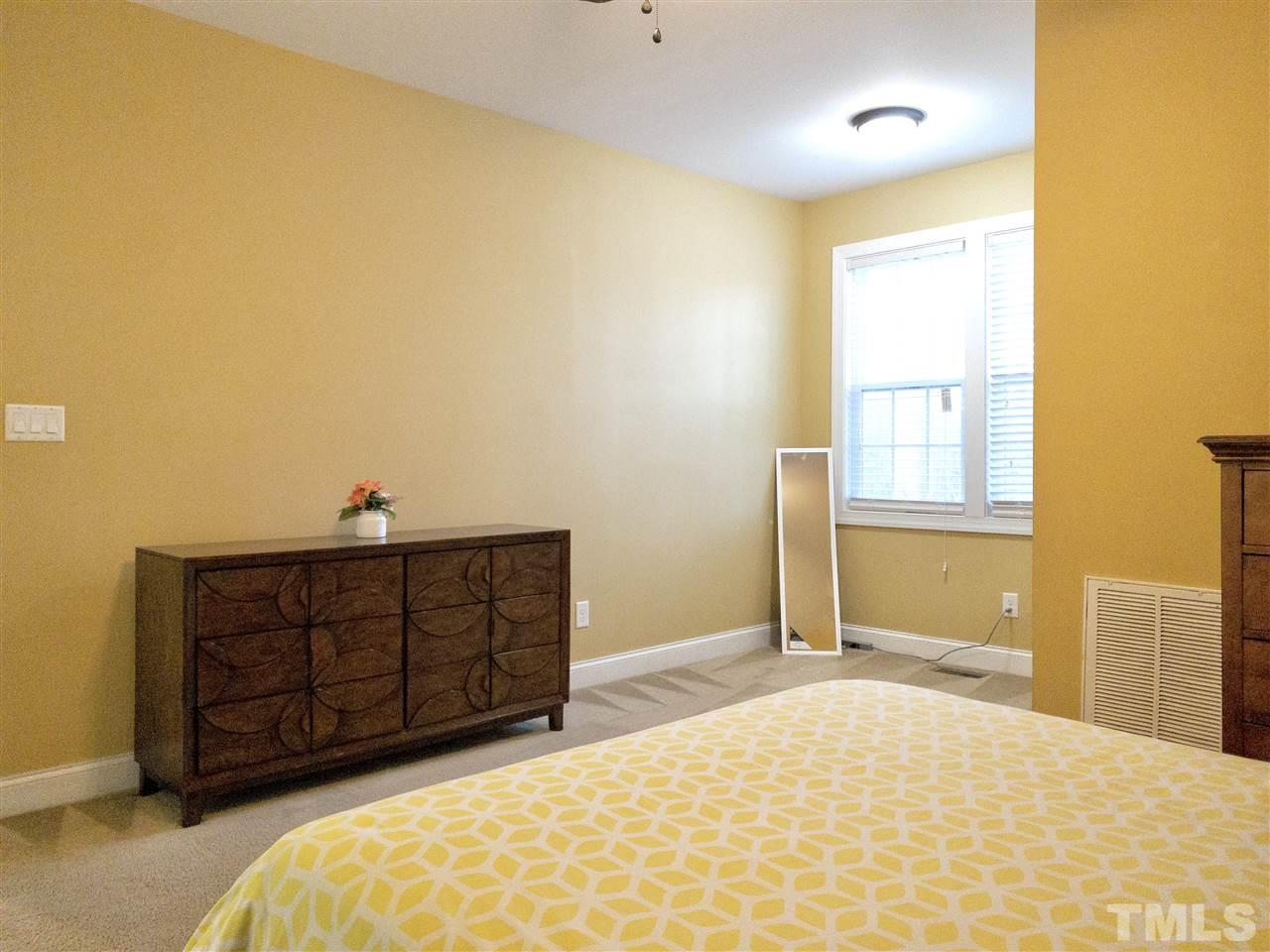 2513 Friendly Trail Raleigh, NC 27610 - Photo 15 of 29 a bedroom with a bed and a dresser