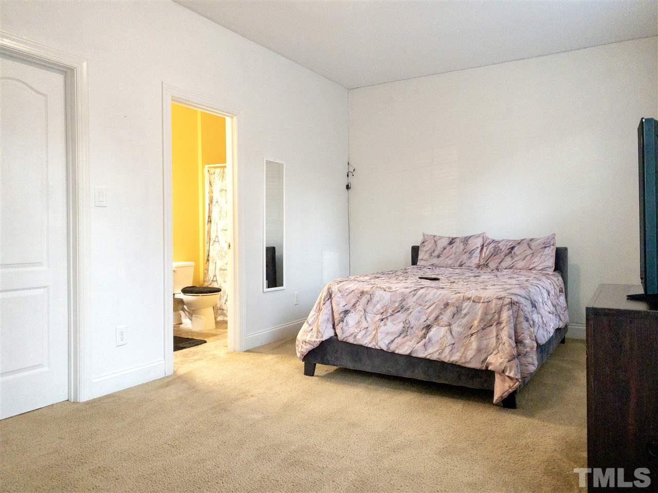 2513 Friendly Trail Raleigh, NC 27610 - Photo 18 of 29 a bedroom with a bed and a closet