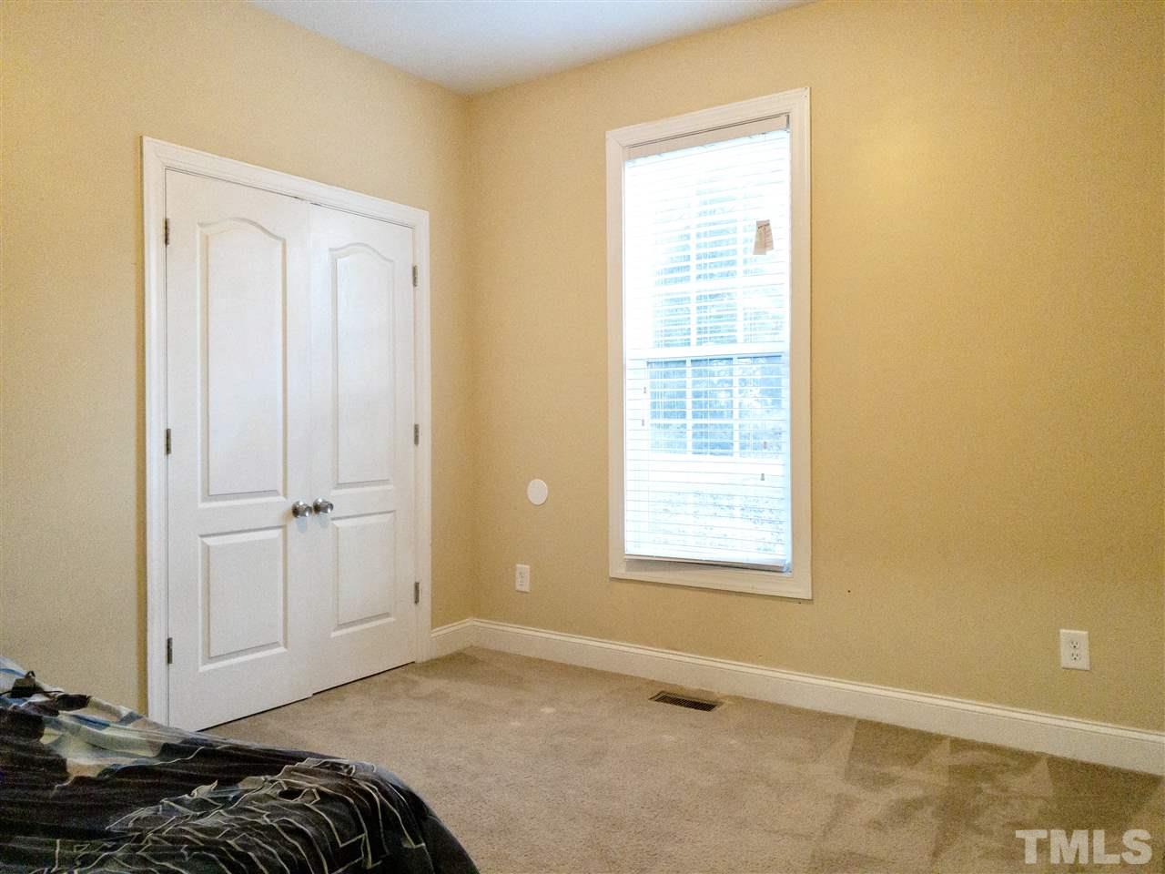 2513 Friendly Trail Raleigh, NC 27610 - Photo 20 of 29 a bedroom with a bed and a window