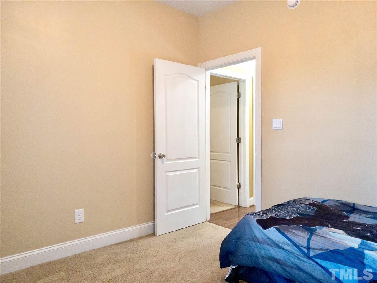 2513 Friendly Trail Raleigh, NC 27610 - Photo 21 of 29 a bedroom with a bed and a hallway