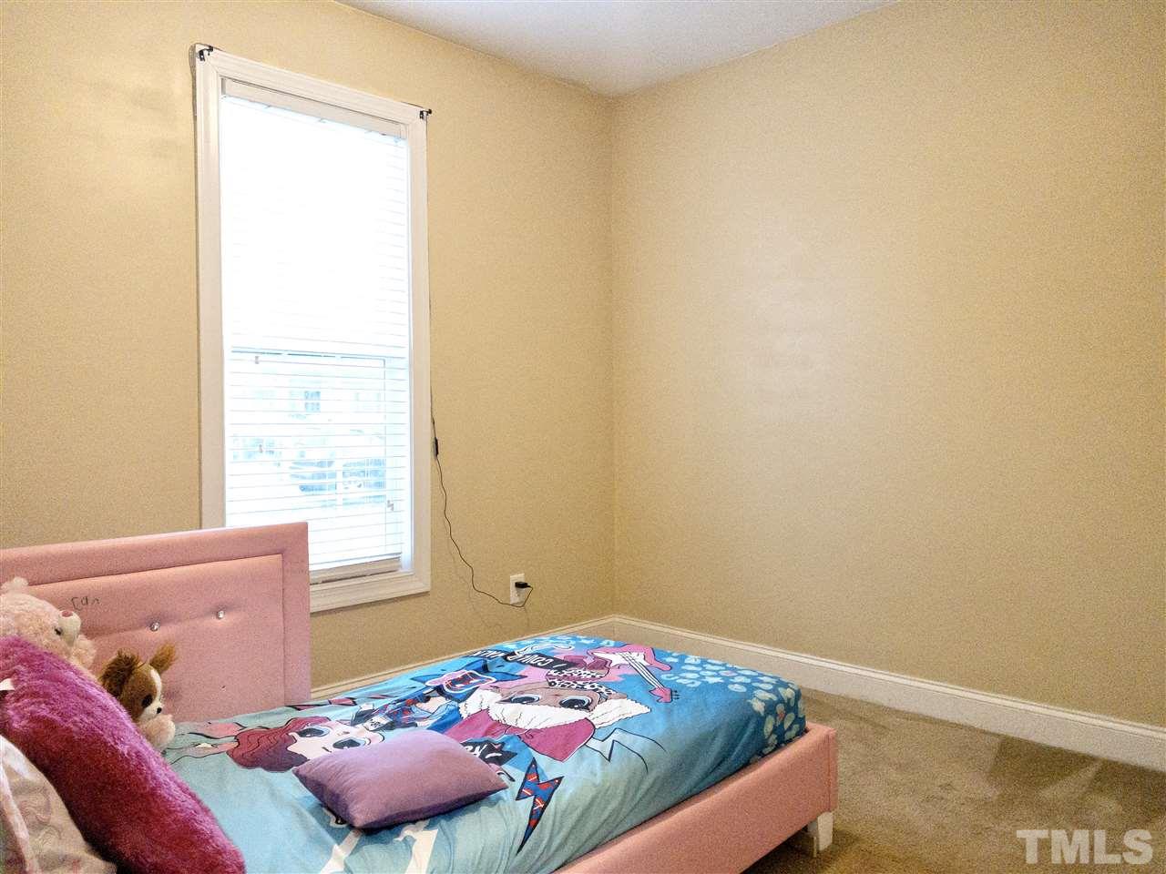 2513 Friendly Trail Raleigh, NC 27610 - Photo 22 of 29 a bedroom with a bed and a window