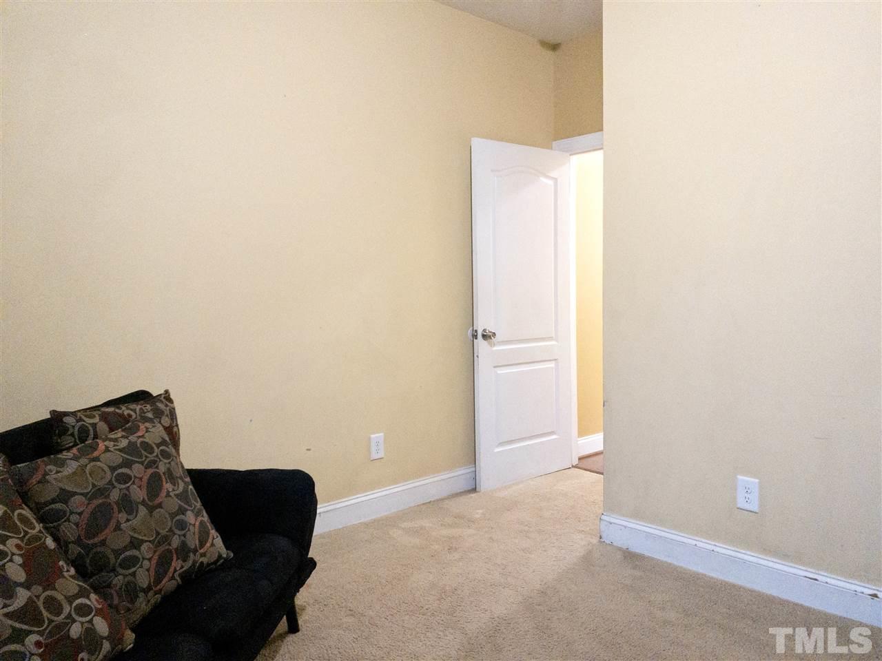 2513 Friendly Trail Raleigh, NC 27610 - Photo 25 of 29 a bedroom with a bed and a couch