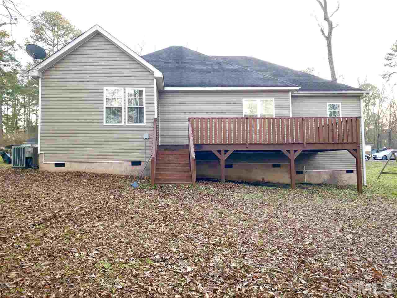 2513 Friendly Trail Raleigh, NC 27610 - Photo 28 of 29 a view of a house with a yard and deck