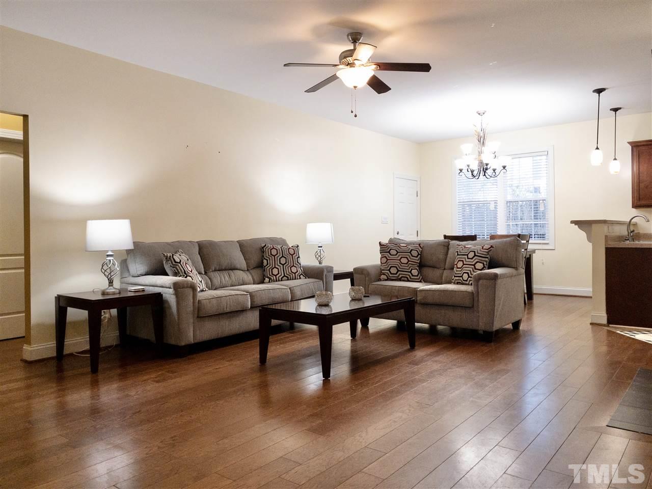 2513 Friendly Trail Raleigh, NC 27610 - Photo 5 of 29 a living room with furniture a fireplace and wooden floor