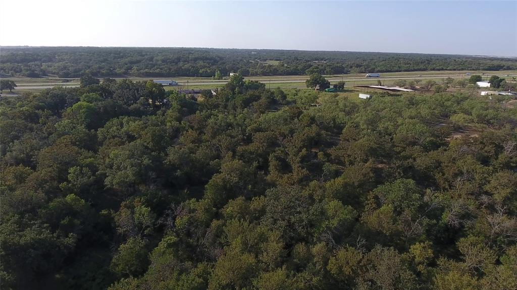 20 Ih Santo, TX 76472 - Photo 14 of 38 Aerial view of property and surrounding area with a forest