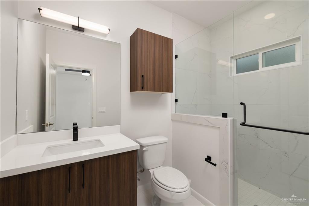 3501 Mary Lane, Unit 4 Weslaco, TX 78599 - Photo 6 of 10 a bathroom with a sink toilet and shower