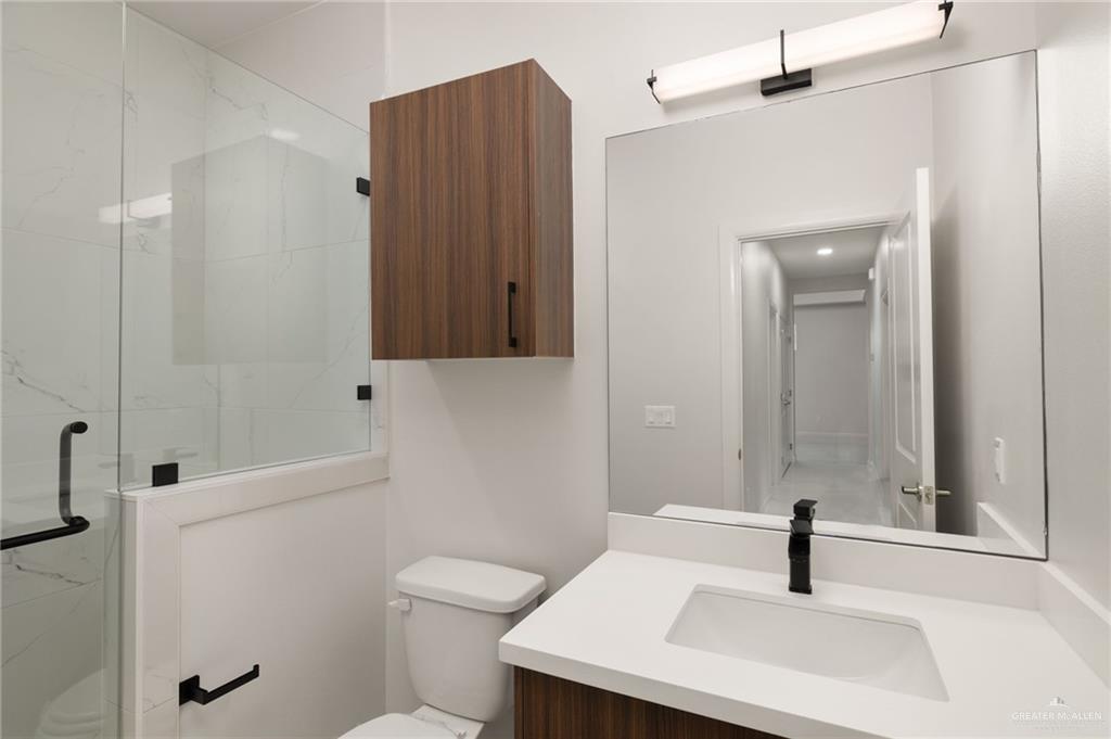 3501 Mary Lane, Unit 4 Weslaco, TX 78599 - Photo 9 of 10 a bathroom with a sink a toilet and shower